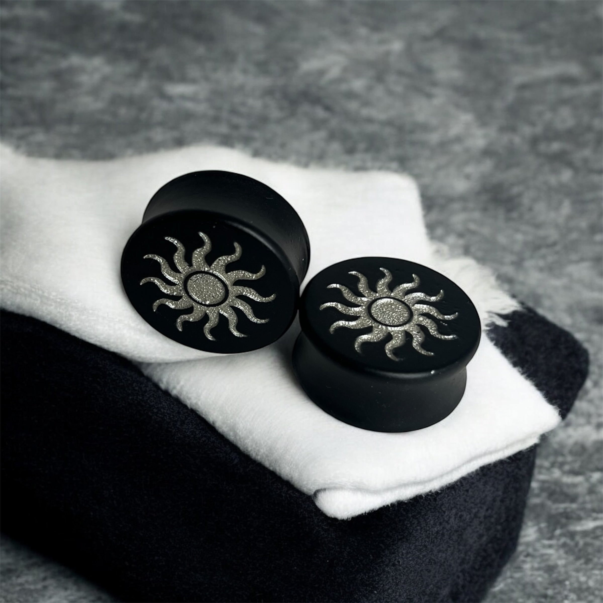 Double Flared Black Wood Saddle Plug With Tribal Sun